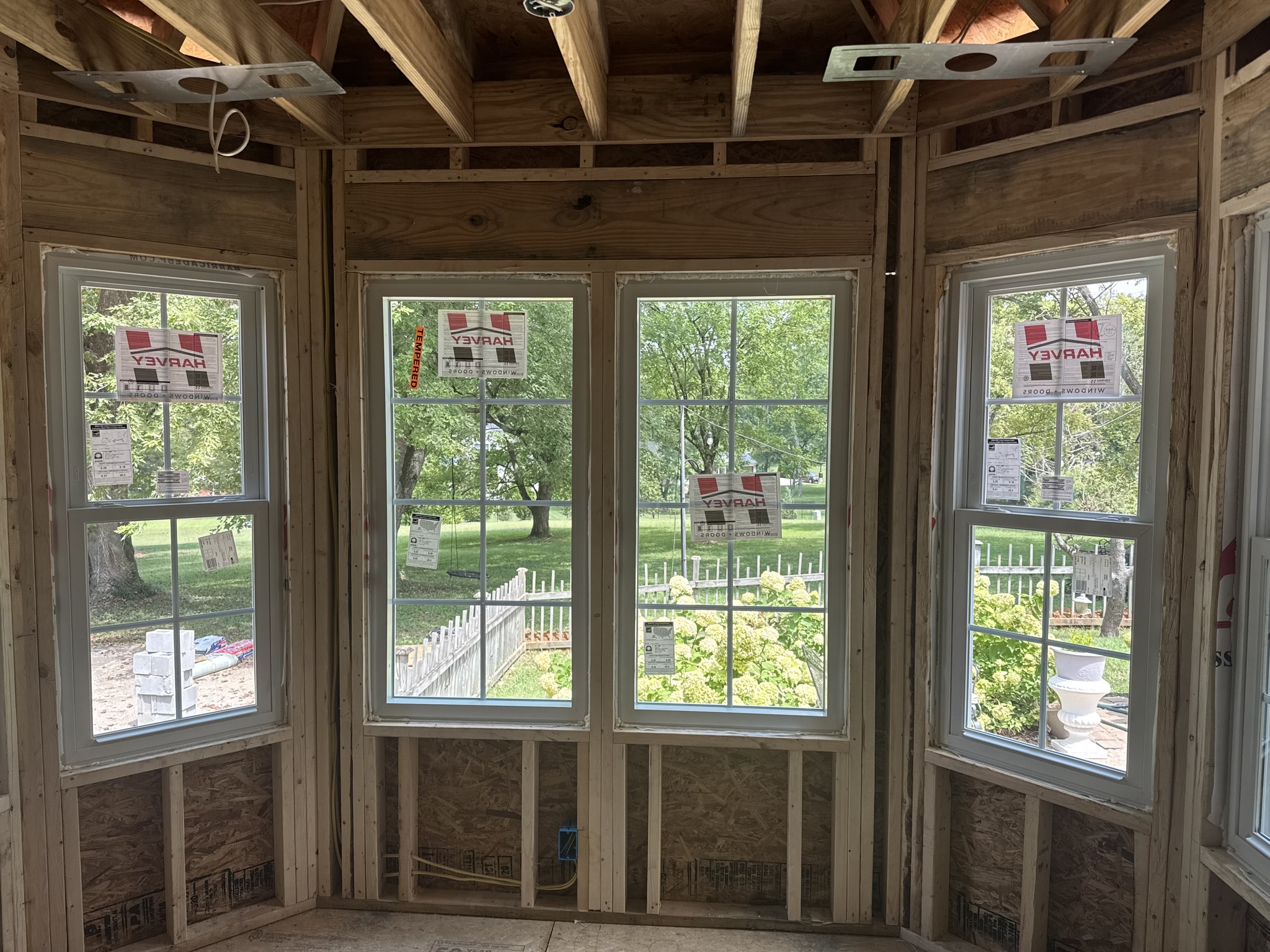 Window Replacement in Nashville, TN, Door specialist aligning custom entry door frame for secure professional installation, Installer carefully fitting replacement window frame for precise long-lasting home performance, Premium replacement windows installed in a bright open-concept living room renovation