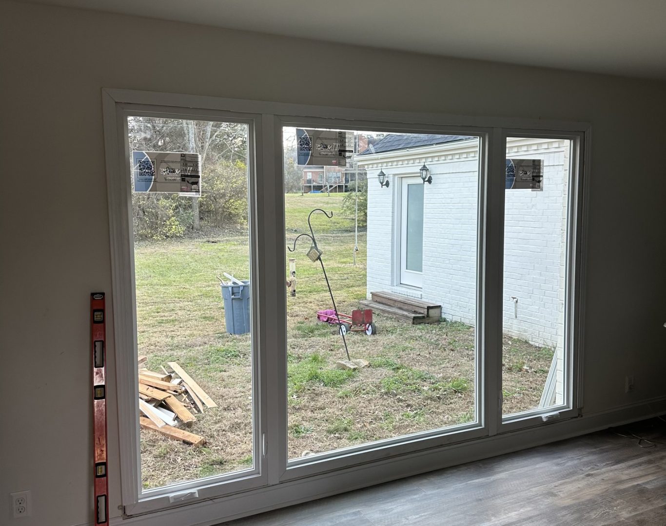 why choose Skylight Windows, Doors, Roofing for Expert Window And Door Replacement in Nashville, TN, Window specialist checking insulated glass performance with precise installation tools, New affordable replacement windows brightening a family room in a suburban home