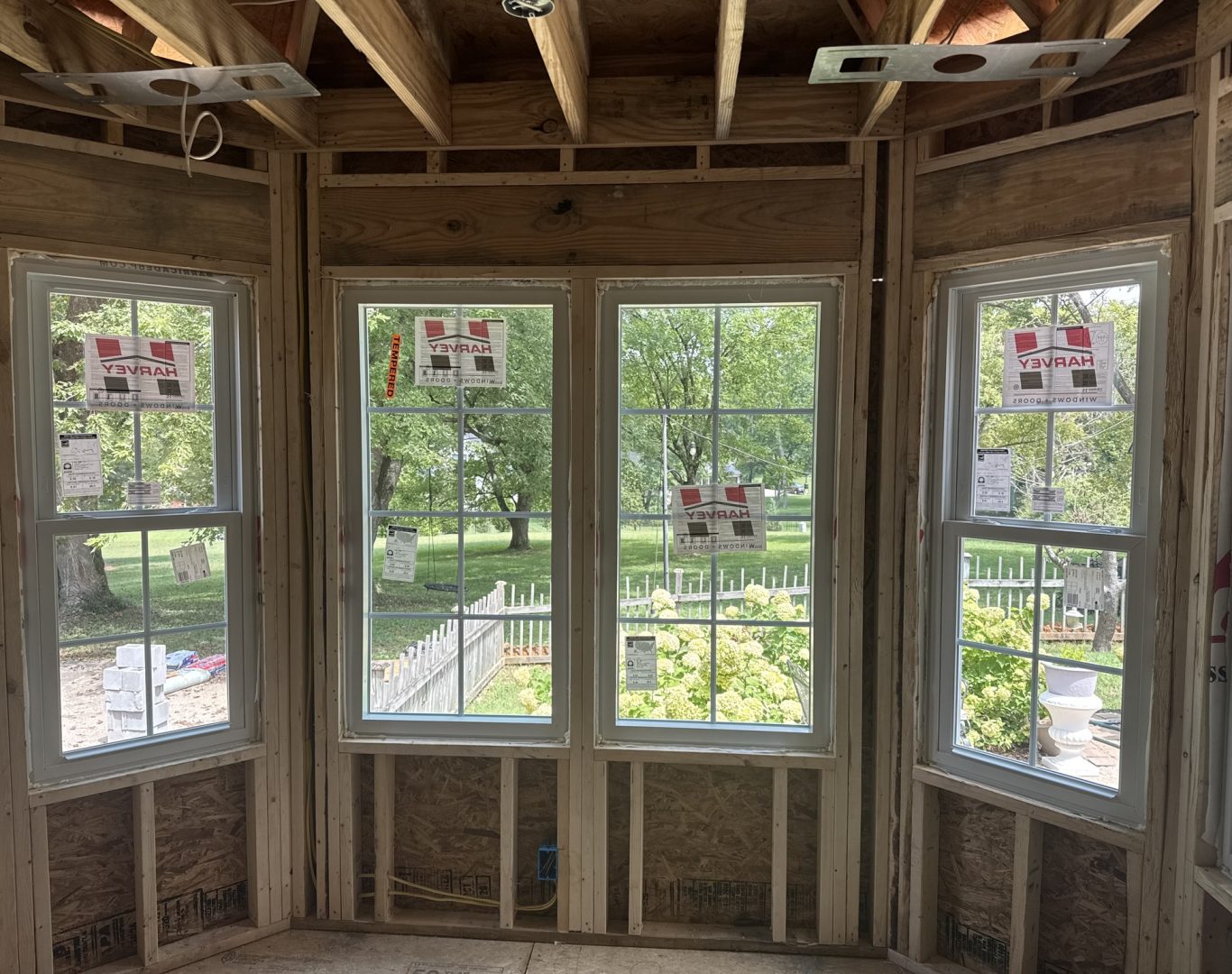 Window Replacement in Nashville, TN, Door specialist aligning custom entry door frame for secure professional installation, Installer carefully fitting replacement window frame for precise long-lasting home performance, Premium replacement windows installed in a bright open-concept living room renovation
